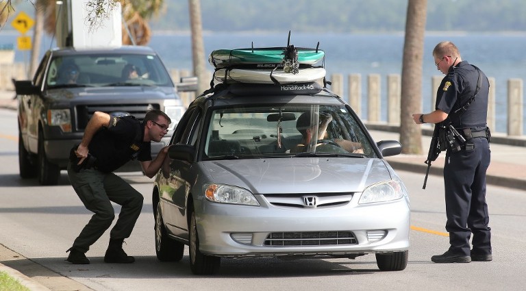 Authorities stop vehicles along Beach Drive in Panama City after a Florida Fish and Wildlife Conservation Commission officer was shot on Friday afternoon. (Panama City Photographer | Andrew Wardlow)