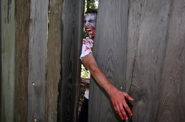 A zombie freaks out runners during third annual Running Scared Zombie 5k Run at Harder's Park in Panama City. (Panama City Photographer/Andrew Wardlow)