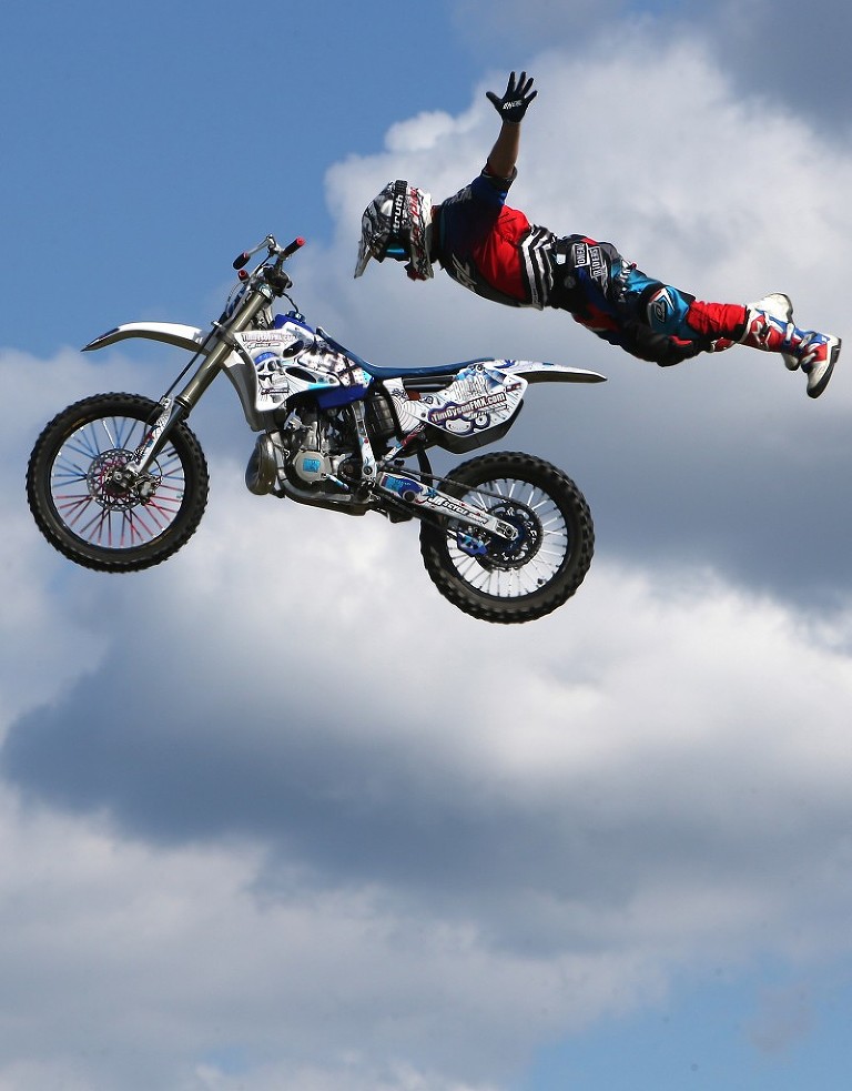Tim Dyson performs during a motocross stunt show at Frank Brown Park.  ANDREW WARDLOW/The News Herald