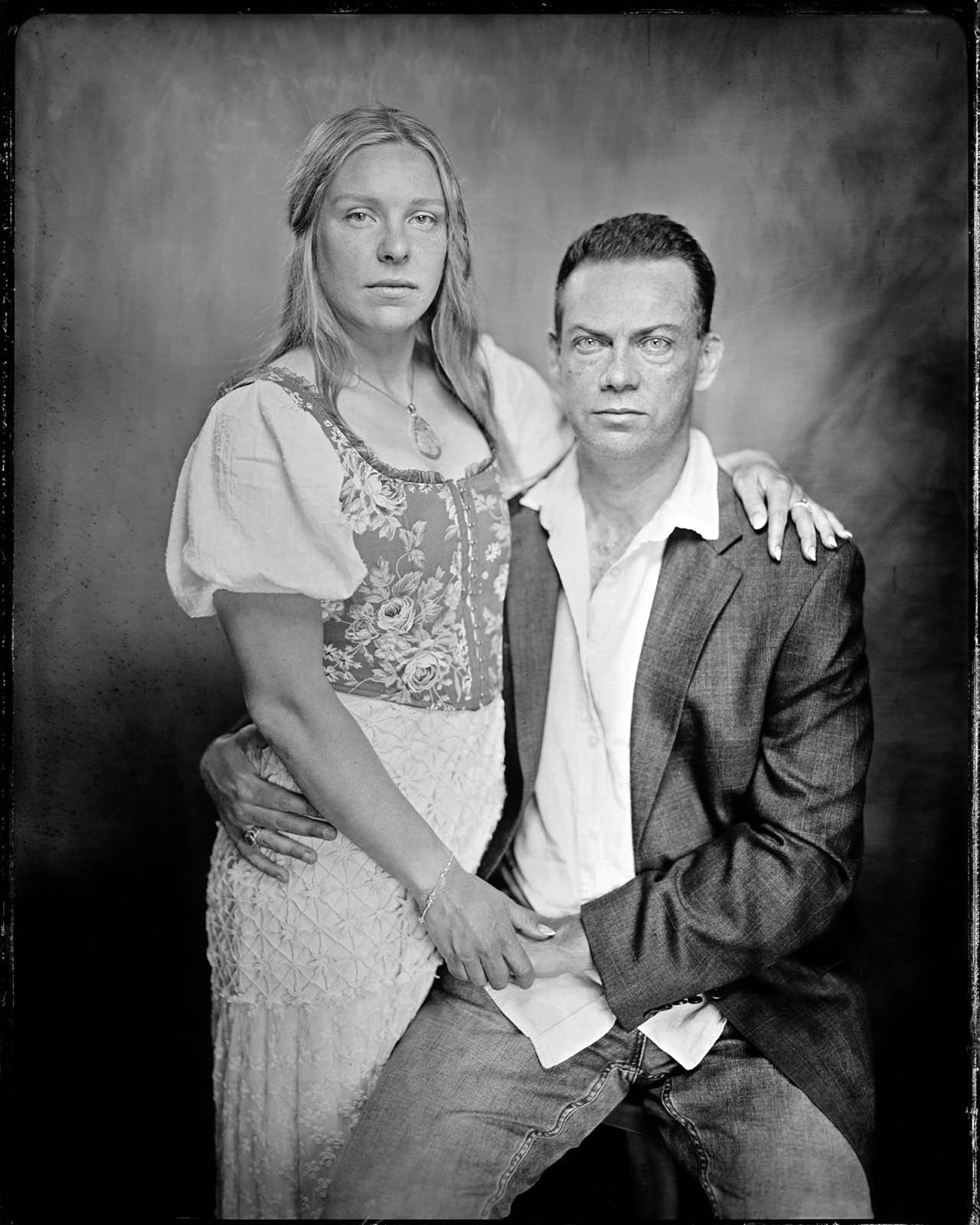 A tintype photo of a couple sitting in Panama City Beach Photographer Andrew Wardlow's tintype studio.