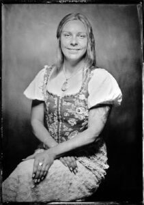 A tintype photo of a girl sitting in Panama City Beach Photographer Andrew Wardlow's tintype studio.