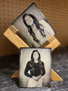 Two tintype photos are seen in the darkroom of Andrew's Panama City Beach tintype darkroom.