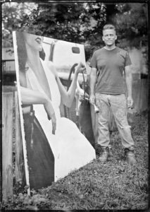 Tintype or wet plate photograph of an artist with an unfinished painting.