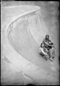 Tintype or wet plate photograph of a father and son at a skatepark.