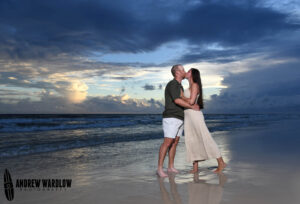 A couple kisses at sunset in Panama City Beach, Florida.