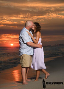 A couple shares a kiss as the sun goes down along Panama City Beach, Florida.