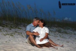 A couple sits among the sea oates as they are photographed in Panama City Beach, Florida.