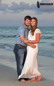 A young couple smiles for the camera in Panama City Beach, Florida.