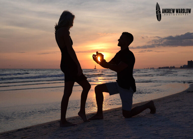 A man proposes to a woman at sunset in Panama City Beach, Florida. 