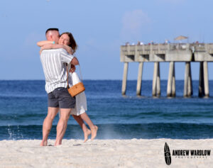 A couple celebrates after getting engaged in Panama City Beach, Florida.
