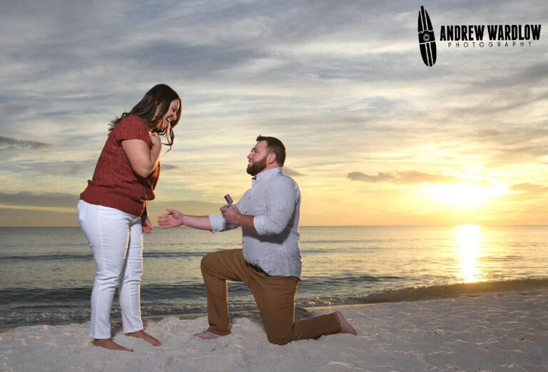 A man proposes to a woman during a beach proposal photo session in Panama City Beach, Florida.