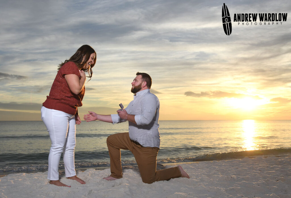 A man proposes to a woman during a beach proposal photo session in Panama City Beach, Florida.